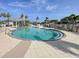 Resort-style pool with a relaxing, curved design and spacious deck at 10501 Amberjack Way # 103, Englewood, FL 34224