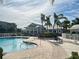 Resort-style pool with lounge chairs and landscaping at 10501 Amberjack Way # 103, Englewood, FL 34224