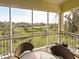 Relaxing screened balcony with scenic water views and patio furniture at 10501 Amberjack Way # 103, Englewood, FL 34224