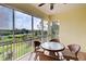 Peaceful screened balcony boasts scenic nature views and a ceiling fan at 10501 Amberjack Way # 103, Englewood, FL 34224