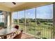 Serene screened balcony features scenic water views and patio seating at 10501 Amberjack Way # 103, Englewood, FL 34224