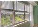 Bedroom window view of lush greenery and water at 10501 Amberjack Way # 103, Englewood, FL 34224
