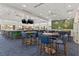 Upscale bar with green tile and blue chairs at 10984 Trevino St, Englewood, FL 34223