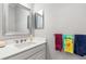 Clean bathroom with single sink vanity and a framed mirror at 10984 Trevino St, Englewood, FL 34223