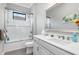 Clean bathroom with shower/tub combo, single vanity, and a large mirror at 10984 Trevino St, Englewood, FL 34223