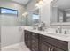 Bright bathroom with double sinks, stylish tile work, and a walk in shower at 10984 Trevino St, Englewood, FL 34223