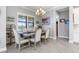 Elegant dining room with wood table, neutral chairs, and window seating at 10984 Trevino St, Englewood, FL 34223