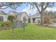 Clubhouse entrance with a sign and landscaping at 10984 Trevino St, Englewood, FL 34223