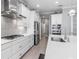 Clean kitchen with white cabinets, stainless steel appliances, and long island at 10984 Trevino St, Englewood, FL 34223