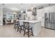 Modern kitchen with white cabinets, stainless steel appliances, and island at 10984 Trevino St, Englewood, FL 34223