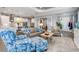 Open living room with multiple seating areas and access to kitchen at 10984 Trevino St, Englewood, FL 34223