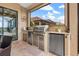 Stainless steel appliances and granite countertops in outdoor kitchen at 10984 Trevino St, Englewood, FL 34223