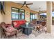 Relaxing patio seating area with fire pit and wicker furniture at 10984 Trevino St, Englewood, FL 34223
