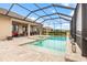 Inviting pool area with screened enclosure, spa, and patio at 10984 Trevino St, Englewood, FL 34223