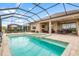 Inviting pool and spa area with covered patio and lounge chairs at 10984 Trevino St, Englewood, FL 34223