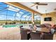 View of refreshing pool and relaxing patio furniture at 10984 Trevino St, Englewood, FL 34223