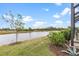 Peaceful waterfront view with lush landscaping at 10984 Trevino St, Englewood, FL 34223