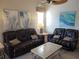 Living room with two leather sofas and a coffee table at 111 Woodbridge Dr # 204, Venice, FL 34293