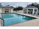 Community pool with lounge chairs and restrooms nearby at 111 Woodbridge Dr # 204, Venice, FL 34293