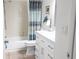 Clean bathroom with a shower/tub combo, modern vanity, and tile flooring at 112 Jose Gaspar Dr # 112, Englewood, FL 34223
