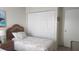 Guest bedroom with twin beds, wicker headboards, and large closet at 112 Jose Gaspar Dr # 112, Englewood, FL 34223