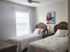 Bright bedroom with twin beds and beach-themed bedding at 112 Jose Gaspar Dr # 112, Englewood, FL 34223