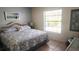 King-size bed in a well-lit bedroom with coastal decor at 112 Jose Gaspar Dr # 112, Englewood, FL 34223
