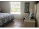 Bright bedroom with a king-size bed and large window at 112 Jose Gaspar Dr # 112, Englewood, FL 34223