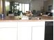 Kitchen with island, double sink, and view of living room at 112 Jose Gaspar Dr # 112, Englewood, FL 34223