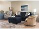 Living area with navy couch and wicker furniture at 112 Jose Gaspar Dr # 112, Englewood, FL 34223