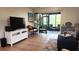 Living room with flatscreen TV and access to lanai at 112 Jose Gaspar Dr # 112, Englewood, FL 34223
