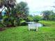 Serene pond with fountain and bench, perfect for relaxing at 112 Jose Gaspar Dr # 112, Englewood, FL 34223