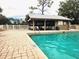 Community pool with covered patio and plenty of seating at 112 Jose Gaspar Dr # 112, Englewood, FL 34223