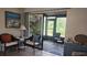 Bright sunroom with wicker furniture and access to the outdoors at 112 Jose Gaspar Dr # 112, Englewood, FL 34223