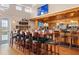 Community clubhouse bar with seating and large screen TV at 1206 Tuscany Blvd, Venice, FL 34292