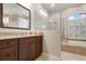 Bathroom with granite countertop double vanity and walk-in shower at 1206 Tuscany Blvd, Venice, FL 34292