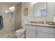 Bathroom with a walk-in shower, granite countertop, and white cabinets at 1206 Tuscany Blvd, Venice, FL 34292