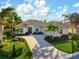 One-story home with a welcoming front porch and mature landscaping at 1206 Tuscany Blvd, Venice, FL 34292