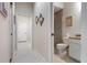 Hallway with tile flooring leading to bedrooms and bathroom at 1206 Tuscany Blvd, Venice, FL 34292