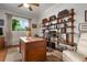 Home office with built-in shelving and hardwood floors at 1206 Tuscany Blvd, Venice, FL 34292