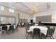 Elegant meeting room featuring a large screen and chandelier at 1206 Tuscany Blvd, Venice, FL 34292