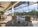 Covered patio with pool and lake views, outdoor furniture, and a relaxing atmosphere at 1206 Tuscany Blvd, Venice, FL 34292