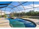 Relaxing screened-in pool and spa overlooking a serene waterway at 1206 Tuscany Blvd, Venice, FL 34292