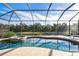 Relaxing screened-in pool and spa with a view of water at 1206 Tuscany Blvd, Venice, FL 34292