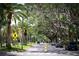 Scenic tree-lined street with lush landscaping and homes at 1206 Tuscany Blvd, Venice, FL 34292