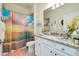 Bathroom with beach-themed shower curtain and granite countertop at 12391 Amica Loop, Venice, FL 34293