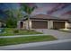 Two-car garage, landscaped yard, and attractive exterior at 12391 Amica Loop, Venice, FL 34293