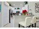 Kitchen with breakfast bar and white cabinetry at 12391 Amica Loop, Venice, FL 34293