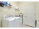 Convenient laundry room with washer, dryer, and shelving at 12391 Amica Loop, Venice, FL 34293