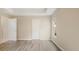 Bright bedroom with wood-look flooring and a double door closet at 12460 Shimmering Oak Cir, Venice, FL 34293